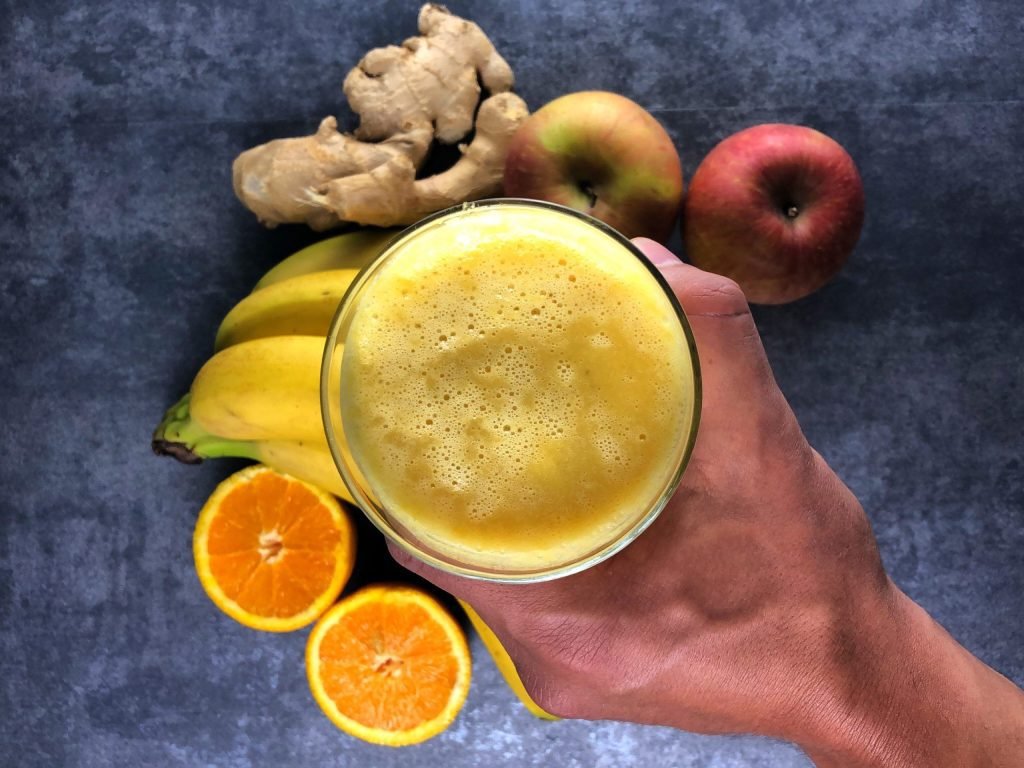 Smoothie ενέργειας με τζίντζερ και μπανάνα, δροσερό και τονωτικό ρόφημα σε ποτήρι